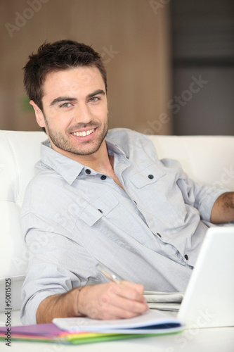 Photo: Man working from living room Man working from living room
