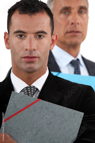 Photo: Businessmen holding documents Businessmen holding documents