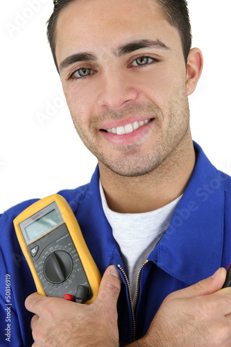Photo: Young electrician smiling on white background Young electrician smiling on white background