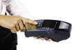 Hand and fingers entering pin with a hand held pin pad