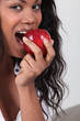 black woman eating an apple