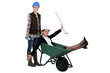 Woman pushing another woman in wheelbarrow