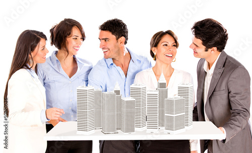 Photo: Group of architects with a building project Group of architects with a building project