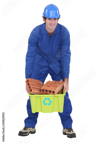 Photo: craftsman carrying a box with bricks craftsman carrying a box with bricks