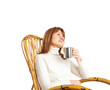 Beautiful woman enjoying a cup of coffee in a rocking chair