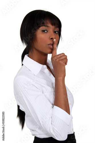 Photo: Businesswoman shushing Businesswoman shushing