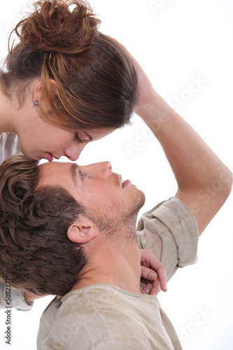 Photo: Woman kissing man on the forehead Woman kissing man on the forehead