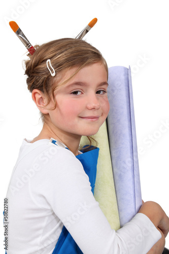Photo: Cute little girl with equipment for home decoration Cute little girl with equipment for home decoration