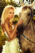 Portrait of gorgeous blonde girl with horse.