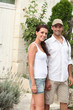 Couple in front of their house