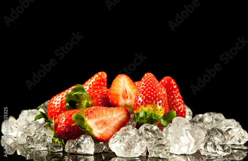Photo: strawberry on black background. strawberries with ice cubes on strawberry on black background. strawberries with ice cubes on
