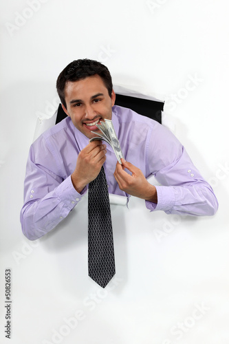 Photo: Happy businessman holding lots of money Happy businessman holding lots of money