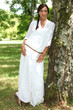 Woman leaning against tree