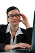 Bored woman sitting at her laptop