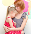 Mother hugging her sad child