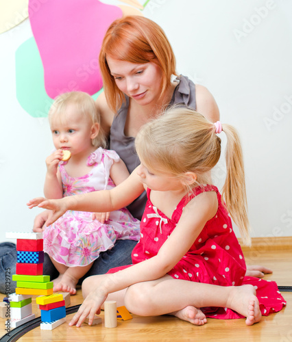 Photo: Little girl and her mother playing with railway Little girl and her mother playing with railway