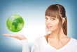 Photo: woman holding green globe on her hand woman holding green globe on her hand