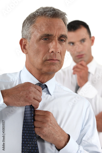 Photo: Businessman fixing his tie Businessman fixing his tie