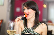 Beautiful woman eating appetizer in a restaurant