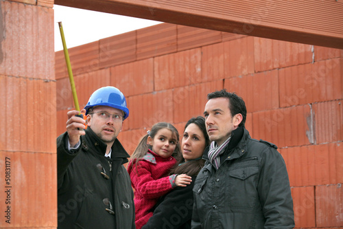 Photo: Architect on site with a young family Architect on site with a young family