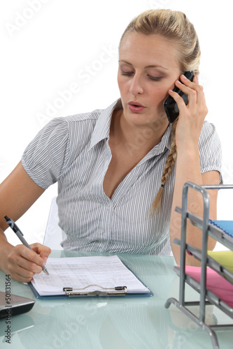 Photo: Receptionist making telephone call Receptionist making telephone call