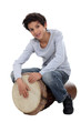 Photo: Young boy playing the djembe Young boy playing the djembe