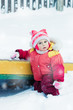 Beautiful happy kid in the red warm clothing.