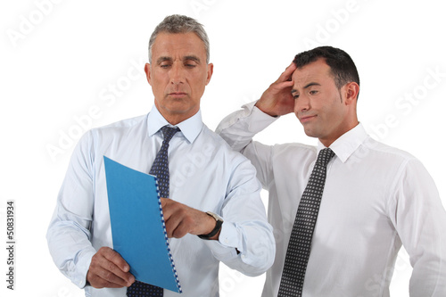 Photo: Boss explaining mistake to employee Boss explaining mistake to employee