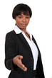A businesswoman about to shake hands.