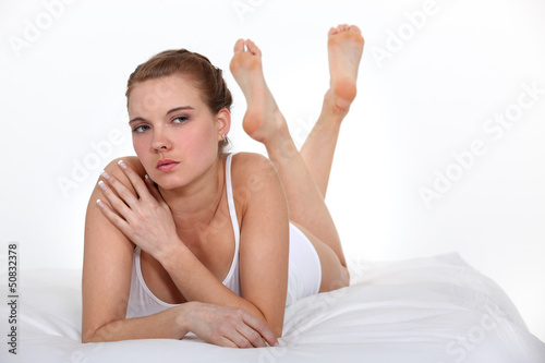 Photo: serious beautiful woman on bed serious beautiful woman on bed