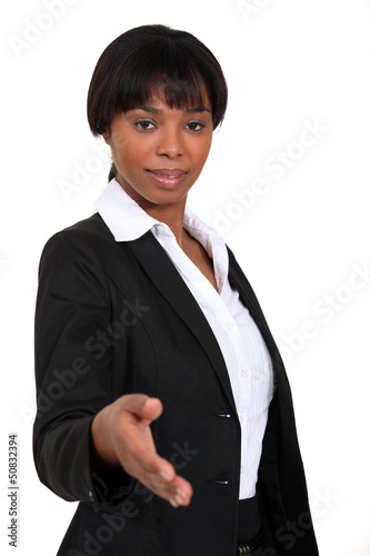 Photo: A businesswoman about to shake hands. A businesswoman about to shake hands.