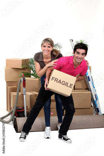 Photo: Playful couple moving house Playful couple moving house