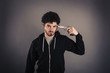 Young man suicide with gun over dark background.