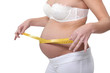 Pregnant woman measuring belly