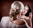 woman looking into a broken mirror