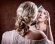 woman looking into a broken mirror