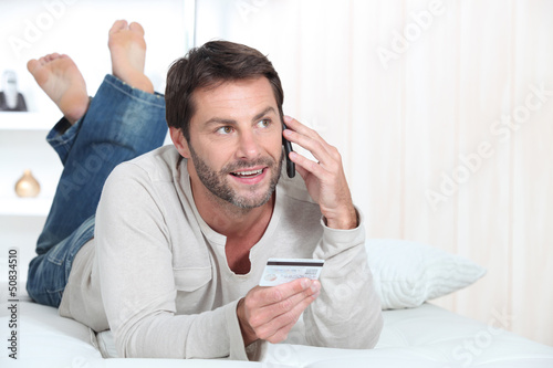 Photo: Man holding credit card Man holding credit card