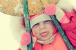 Beautiful happy kid in the red warm clothing