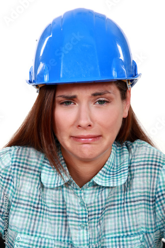Photo: A crying female construction worker. A crying female construction worker.