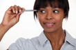 Women with pen pointing towards her temple