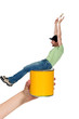Excited male decorator sitting on paint tin