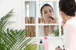 Woman putting on lipstick