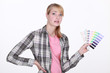 Woman holding up paint samples