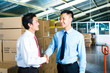 Businesspeople in warehouse have a deal
