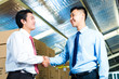 Businesspeople in warehouse have a deal