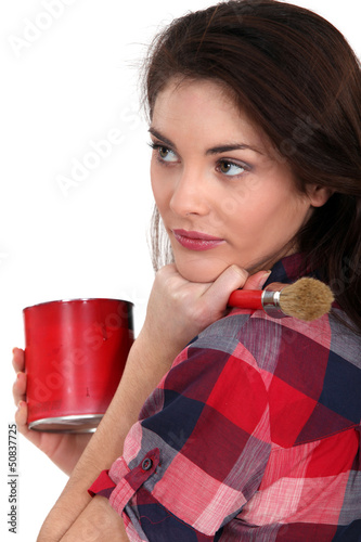 Photo: woman holding a brush and a paint can woman holding a brush and a paint can