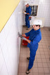 Top view of electricians in a tiled room