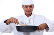 Photo: Woman chef stirring a wok Woman chef stirring a wok