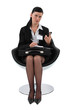 Businesswoman copying a telephone number into her agenda