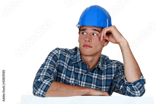 Photo: Anxious young builder Anxious young builder